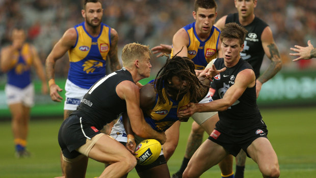 Nic Naitanui is tackled by the Blues.