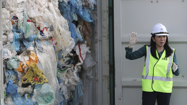 Malaysian Environment and Climate Change Minister Yeo Bee Yin shows plastic waste shipment in Port Klang, Malaysia, on Tuesday.