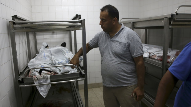 A medic covers the bodies of militants at the morgue of the European hospital east of Khan Younis, southern Gaza, on Friday.