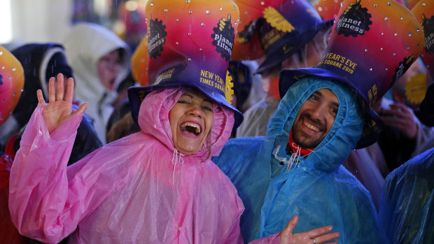 Revellers in rain coats in Times Square, New York City.