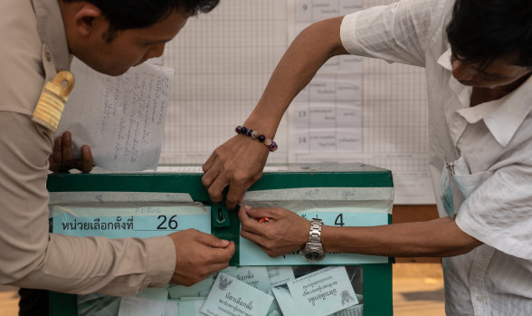 Officials open a sealed ballot box ahead of counting for a general election at a counting centre in Bangkok on Sunday. It was Thailand's first general election since the military seized power five years ago.