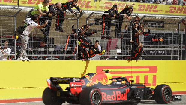 Red Bull team members celebrate Max Verstappen's second place in the US Grand Prix.