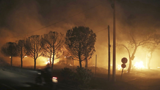 Buildings burn in the town of Mati.