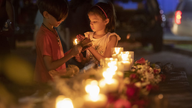 Lucrecia Martinez, 7, and her brother Luciano, 9, of Dickinson light candles during a vigil held in the wake of a deadly school shooting with multiple fatalities at Santa Fe High School in Santa Fe, Texas. 