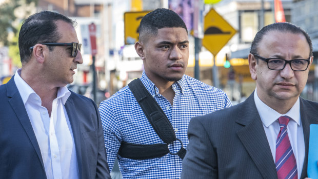 Manly hooker Manase Fainu (centre) is under house arrest  after being hit with three charges relating to an alleged stabbing at a church dance.