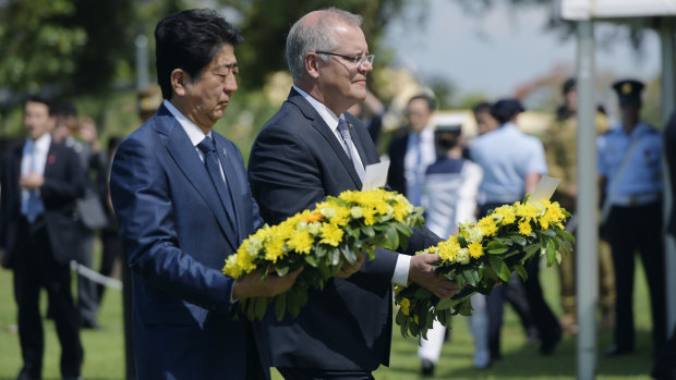 'Deeply symbolic': Japanese PM Shinzo Abe alongside Australian PM Scott Morrison during the laying of wreaths at the Darwin Cenotaph War Memorial.