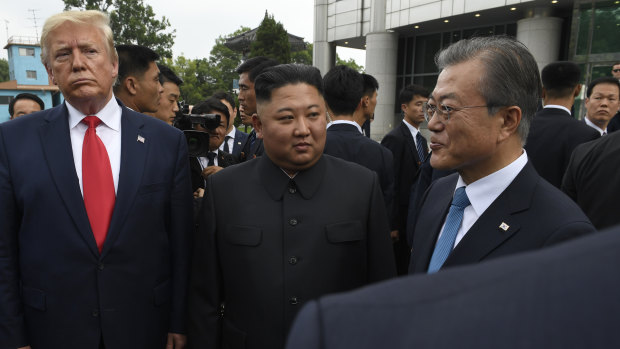 US President Donald Trump, left, North Korean leader Kim Jong-un, centre, and South Korean President Moon Jae-in, right, walk together at the border village of Panmunjom in Demilitarized Zone.