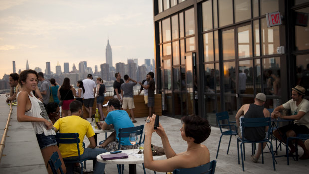 Drinkers enjoy views from the Wythe Hotel, one of several flashy hotels rapidly changing the fabric of Brooklyn. 