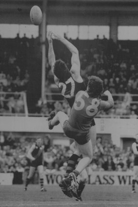 Simon Madden (27) of Essendon & Fitzroy’s Mark Dwyer contest a mark.