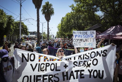 Protesters marching in front of Victoria Police at Pride March.