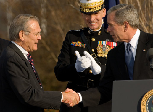 Donald Rumsfeld, left,  shakes hands with President George W. Bush during a 2006 ceremony at the Pentagon honouring Rumsfeld on his final day as defence secretary.  