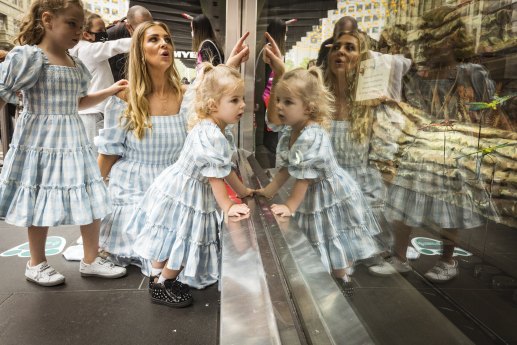 Window on tradition: Lorinska Merrington and daughters Penelope, 5, and Florence, 2, on the first day of the 2021 Myer Christmas Windows in Bourke Street Mall. 