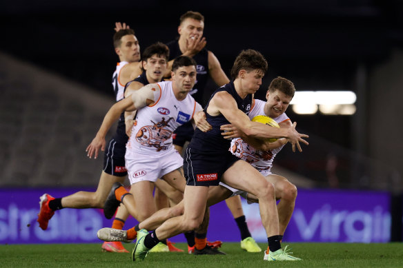 Blues player Sam Walsh is tackled during a match against the Giants in 2021. It was during training in February that he sustained a syndesmosis injury. 