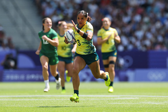 Faith Nathan breaks away to score in the women’s rugby sevens.