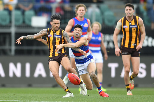 Chad Wingard is tackled by Jason Johannisen.