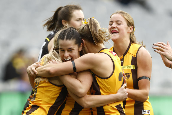 Dominique Carbone and the Hawks celebrate a goal.