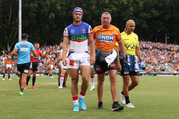 Newcastle’s Kalyn Ponga leaves the field after being concussed in round two.