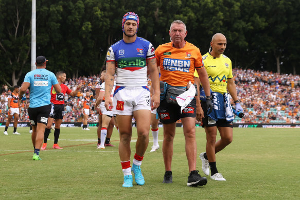 Newcastle’s Kalyn Ponga leaves the field after being concussed against the Tigers last year.