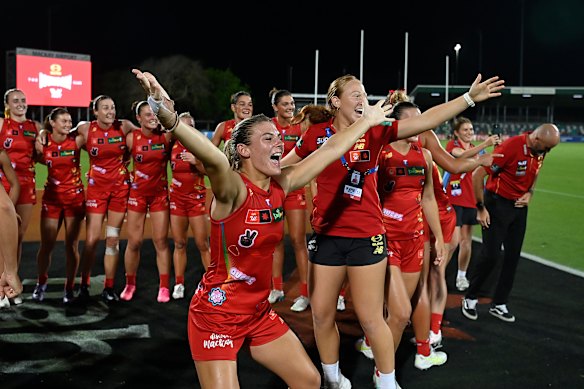 The Suns celebrate after beating Melbourne in Mackay.