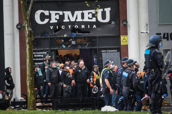Police keep protesters away from the office of the CFMEU in Melbourne on Monday.
