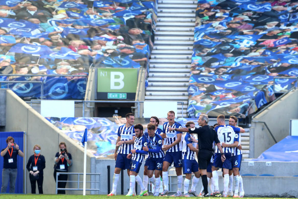 Neal Maupay and his Brighton teammates celebrate his winner against Arsenal.