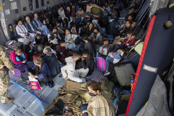 Evacuees sit in a German Bundeswehr airplane in Kabul. 