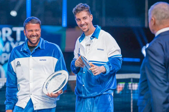 Thanasi Kokkinakis, centre, at the presentation ceremony in St Petersburg with former Serbian player Janko Tipsarevic.