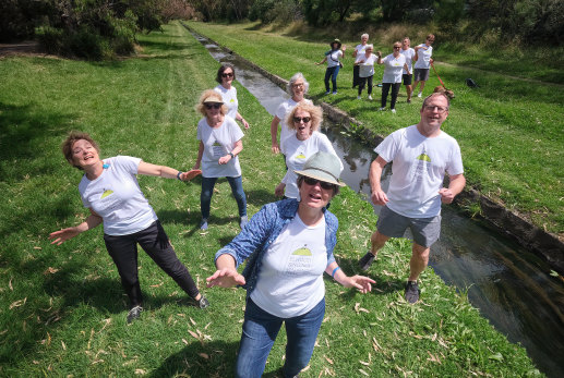 Jeannie Marsh, front, and the Elwood Community Choir sing and dance a piece about the rakali, or native water rat, beside Elwood Canal.