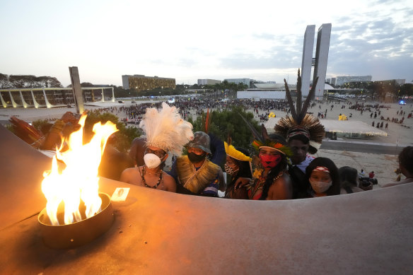 Indigenous people stand near the “Pyre of freedom” during the “Luta pela Vida,” or Struggle for Life mobilization in Brasilia during a protest for Indigenous land rights.