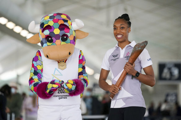 England netballer Layla Guscoth holds the Commonwealth Games baton alongside Perry, the mascot for the Birmingham Games.