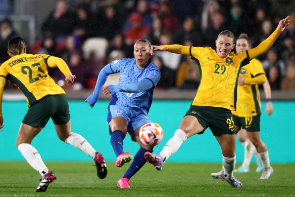 Clare Hunt (right) puts pressure on England’s Lauren James.