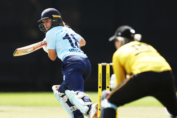 Phoebe Litchfield tucks a delivery away behind point during her century against WA.