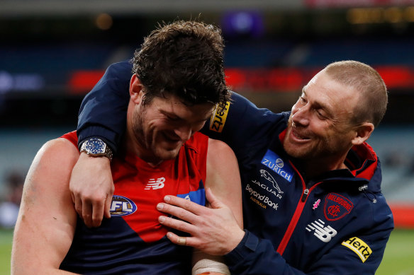 Angus Brayshaw celebrates the Demons’ big win with coach Simon Goodwin.