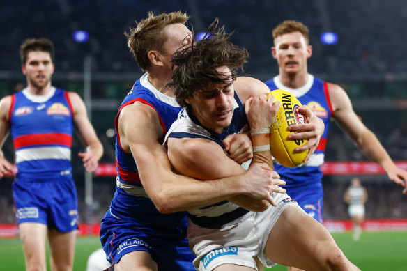 Geelong’s Gryan Miers is tackled by Bailey Dale.