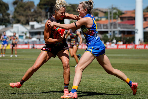 Fend-off: Kaitlyn Ashmore of the Hawks evades West Coast’s Jaide Britton.