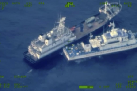 A Chinese militia vessel, top, and Philippine coast guard vessel BRP Cabra as they approach Second Thomas Shoal, locally called Ayungin Shoal, at the disputed South China Sea.