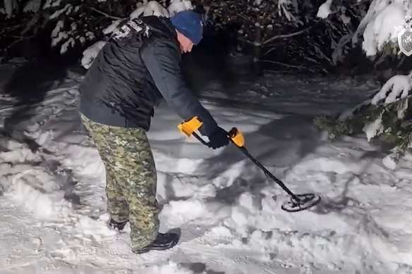 Investigators work at the place where Illia Kyva was killed in a cottage village near Moscow, Russia.