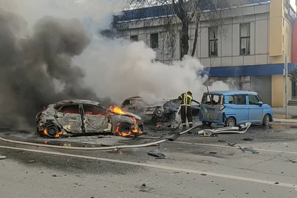 Firefighters extinguish burning cars after shelling in Belgorod, Russia. 