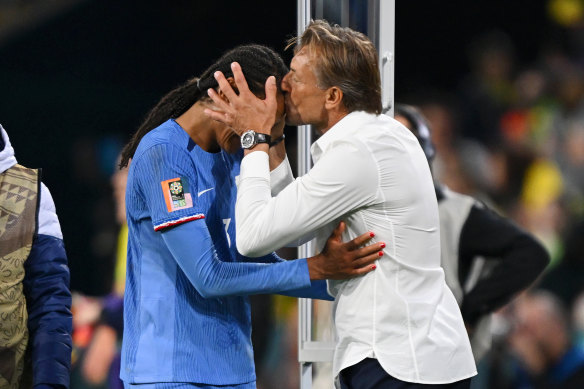 French coach Herve Renard plants a kiss on Wendie Renard’s forehead after her winning goal against Brazil.