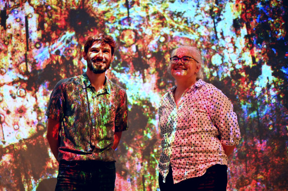 Dr Anthony Lagain and Professor Gretchen Benedix in the dappled light of a Mars crater map.