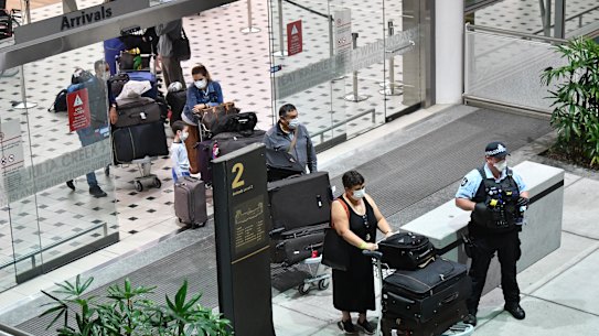 Australians evacuated from South America due to the coronavirus (COVID-19) are seen after landing at Brisbane International Airport in Brisbane, Tuesday, April 14, 2020. The Qantas flight from Lima, repatriated 115 passengers back to Australia. (AAP Image/Darren England) NO ARCHIVING