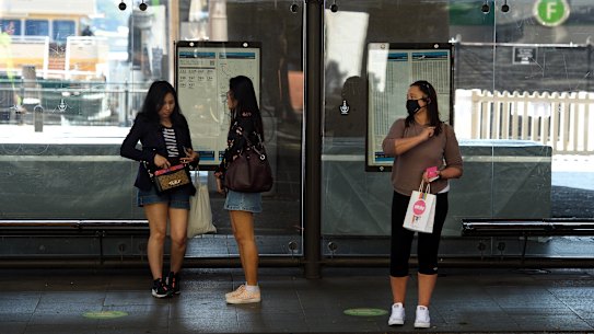 Passengers wait for a bus at Circular Quay on Monday.