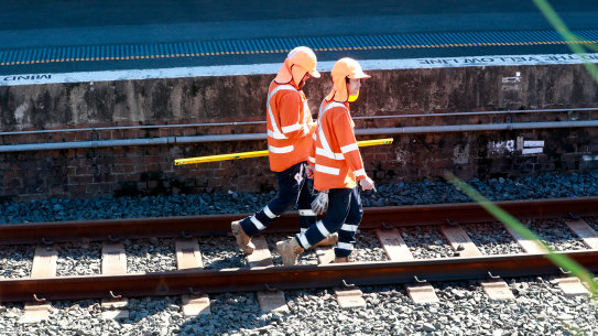 Workers on the Sydenham train station tracks.