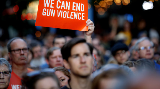 Mourners gather for a vigil at the scene of a mass shooting, Sunday, Aug. 4, 2019, in Dayton, Ohio.