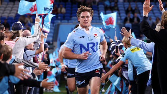 Michael Hooper leads the Tahs out on Saturday.