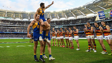 Josh Kennedy of the Eagles is chaired off in his final match by Shannon Hurn and Luke Shuey during the 2022 AFL Round 21 match between the West Coast Eagles and the Adelaide Crows