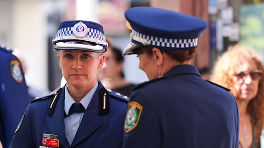 NSW Police Inspector Amy Scott (centre) speaks to NSW Police Commissioner Karen Webb.