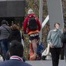 An e-scooter rider weaves through pedestrians on the Evan Walker Bridge in Southbank on Thursday.