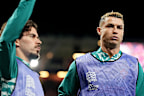 Cristiano Ronaldo (right) and Vitinha of Portugal warm up as substitutes.