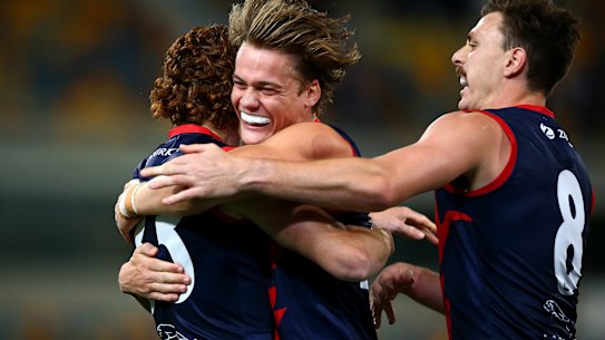 Trent Rivers (centre) celebrates Oskar Baker's goal (left).